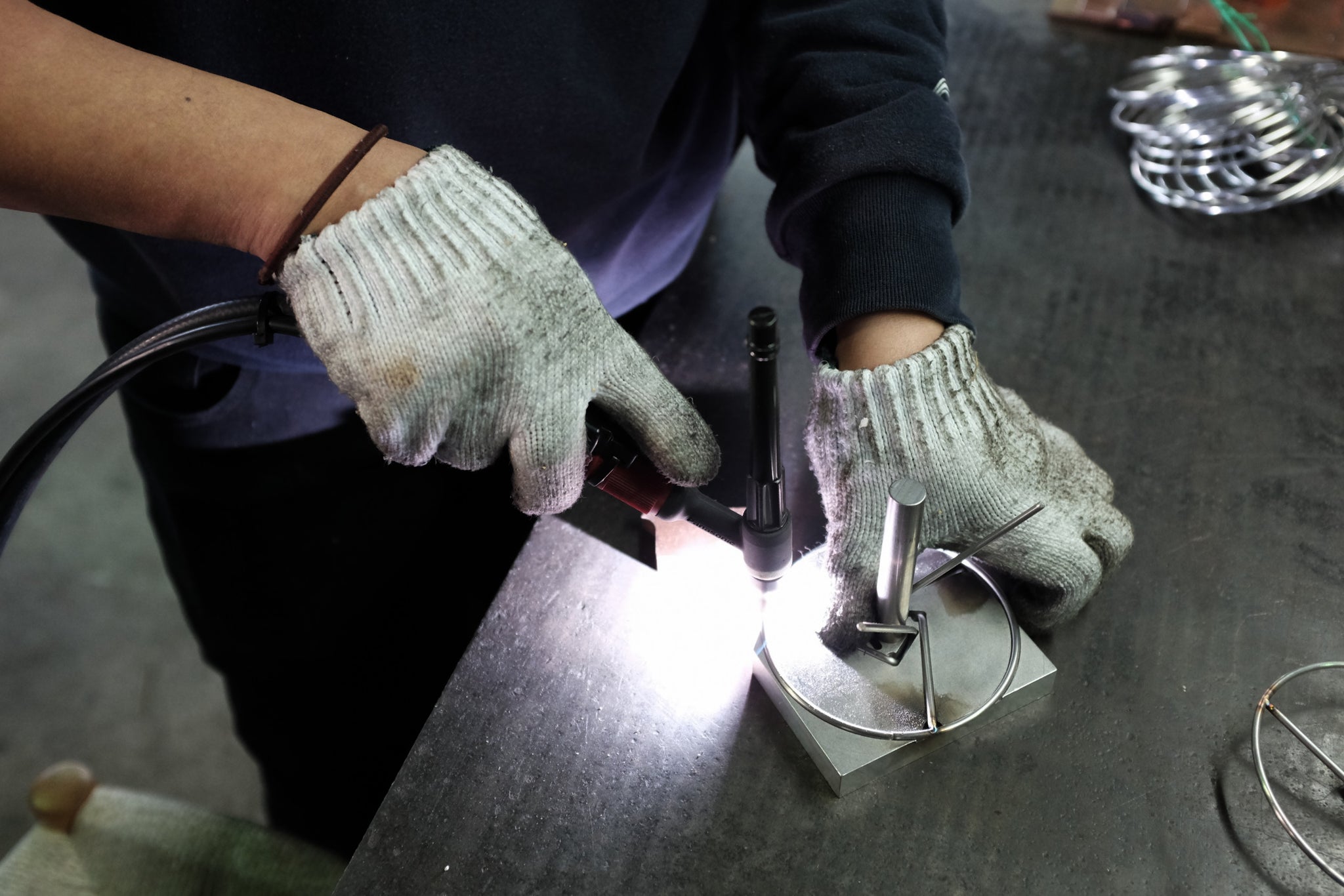 gloved hands preparing japanese metalcrafting