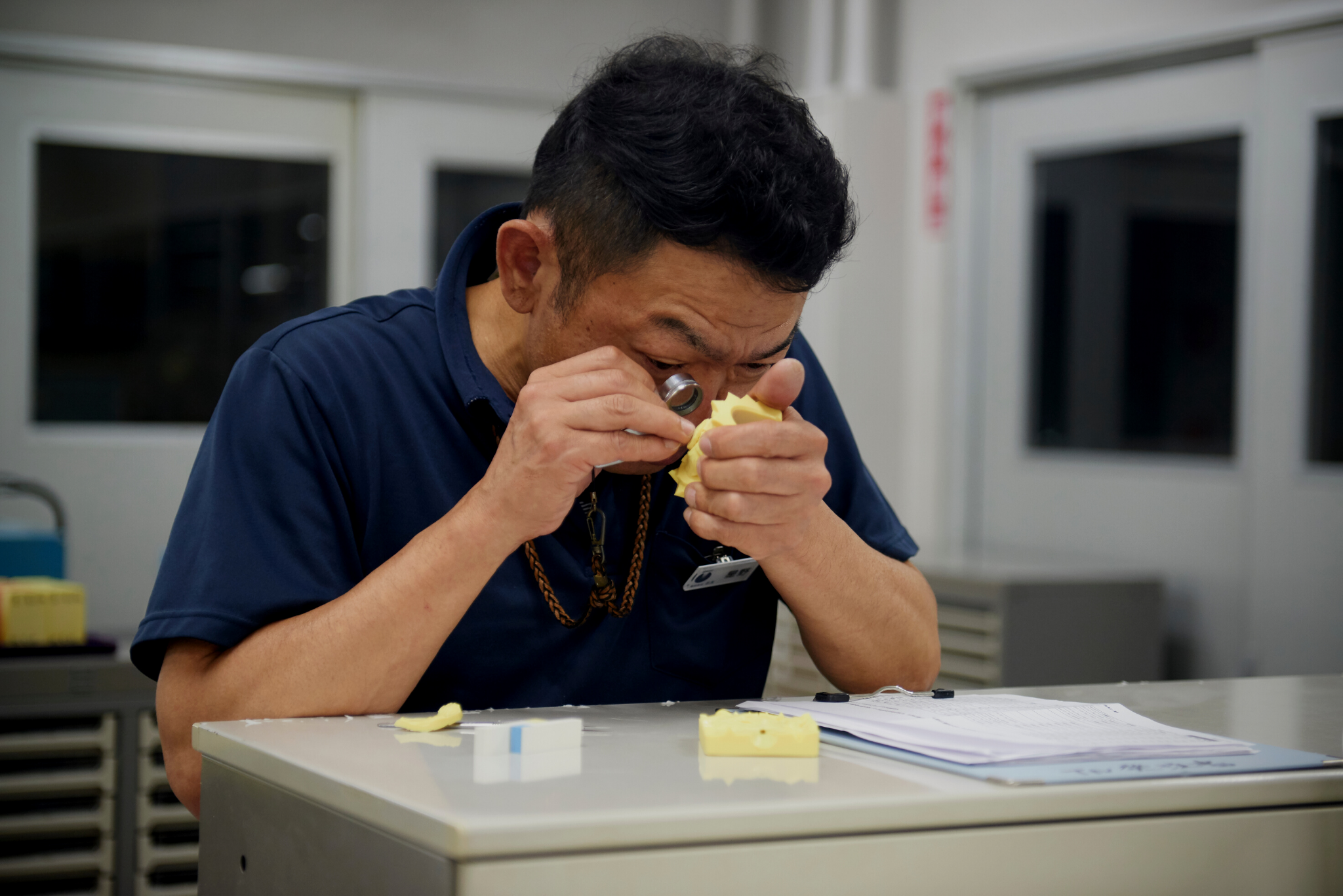 japanese craftsman inspecting fine gems for jewelry