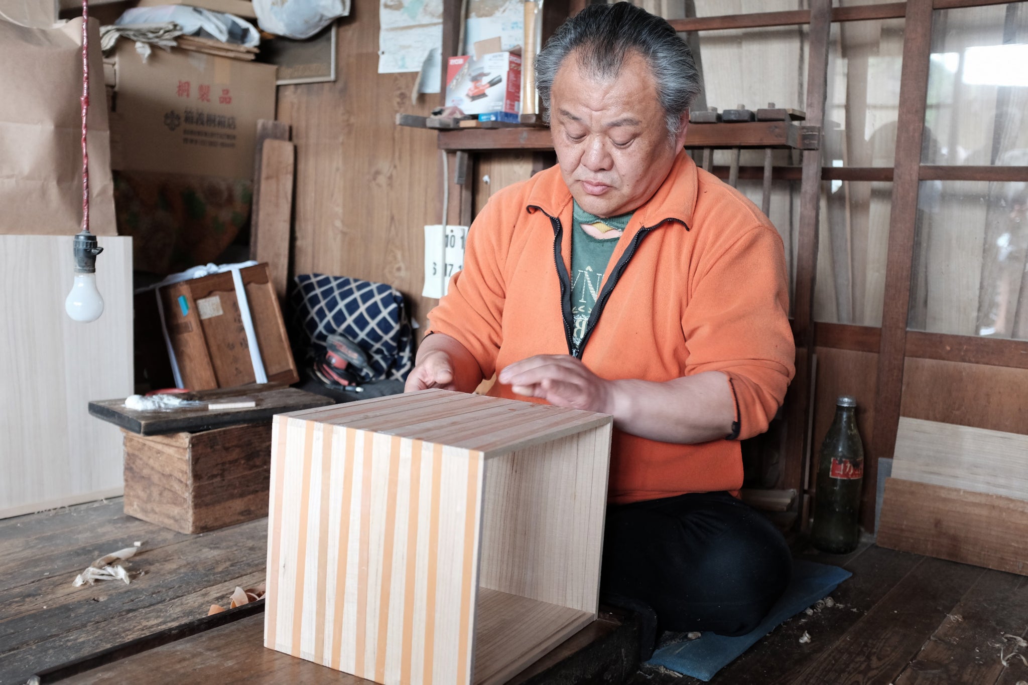 japanese craftsman making a traditional gift box with paulownia wood